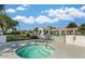 Inviting community hot tub and pool area with pristine landscaping and lounging spaces under a clear blue sky at 7614 E Cactus Wren Rd, Scottsdale, AZ 85250