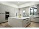 Bright kitchen boasts custom cabinets, a large marble island, and stainless steel appliances, creating an inviting space at 7614 E Cactus Wren Rd, Scottsdale, AZ 85250