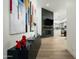 Contemporary living area featuring a fireplace, a TV, stylish console, and an open-concept design with hardwood floors at 7614 E Cactus Wren Rd, Scottsdale, AZ 85250