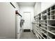 Mudroom and laundry area with a washer and dryer, shoe storage, and cabinets at 7614 E Cactus Wren Rd, Scottsdale, AZ 85250