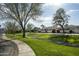 Picturesque neighborhood featuring lush green lawns, mature trees, and well-maintained sidewalks for peaceful living at 7614 E Cactus Wren Rd, Scottsdale, AZ 85250