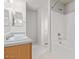Bright bathroom features a double sink vanity, tub and shower combination, and neutral tile flooring at 8924 E Portobello Ave, Mesa, AZ 85212