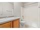 Bright bathroom features single sink, oak cabinets, and tub and shower combination at 8924 E Portobello Ave, Mesa, AZ 85212