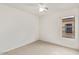 Bright bedroom features neutral carpet, one window, and standard ceiling fan at 8924 E Portobello Ave, Mesa, AZ 85212