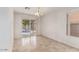 Clean dining room with tile flooring, a chandelier, and sliding glass doors to the backyard pool area at 8924 E Portobello Ave, Mesa, AZ 85212