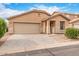 Charming single-Gathering home with a neutral color scheme, two-car garage, and desert landscaping at 8924 E Portobello Ave, Mesa, AZ 85212