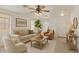 Inviting living room with neutral tones, ceiling fan, and cozy furnishings at 8924 E Portobello Ave, Mesa, AZ 85212