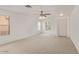 Spacious living room with neutral walls and carpet, featuring a front door and ample natural light at 8924 E Portobello Ave, Mesa, AZ 85212