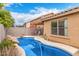 Backyard pool area with privacy wall, attached patio area, and mature landscaping at 8924 E Portobello Ave, Mesa, AZ 85212