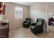 Cozy bedroom featuring two leather chairs and wood-style floors at 9834 E Thatcher Ave, Mesa, AZ 85212