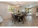 This dining area features wood flooring, designer light fixture, and is open to a living area and patio at 9834 E Thatcher Ave, Mesa, AZ 85212