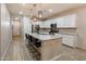 This bright kitchen offers white cabinets, granite countertops, stainless steel appliances, and a large island at 9834 E Thatcher Ave, Mesa, AZ 85212