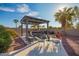 Secluded backyard with a pergola, seating and lush greenery, perfect for outdoor relaxation at 988 W Crooked Stick Dr, Casa Grande, AZ 85122