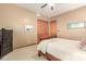 Cozy bedroom with wood-look closet doors, neutral colors and comfortable decor at 988 W Crooked Stick Dr, Casa Grande, AZ 85122