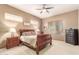 Comfortable bedroom featuring a sleigh bed, ceiling fan, and ample natural light at 988 W Crooked Stick Dr, Casa Grande, AZ 85122