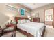 Relaxing bedroom includes a comfortable bed, soft lighting, and a view into the en suite bathroom at 988 W Crooked Stick Dr, Casa Grande, AZ 85122