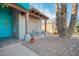 Charming entrance featuring a decorative tile, desert landscaping, and a cozy seating area enhancing curb appeal at 988 W Crooked Stick Dr, Casa Grande, AZ 85122