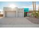 Charming home with a two-car garage, xeriscaping, and a striking turquoise-accented entryway at 988 W Crooked Stick Dr, Casa Grande, AZ 85122