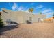 Rear exterior view shows desert landscaping, grill, air conditioner, and access door, adding practical appeal at 988 W Crooked Stick Dr, Casa Grande, AZ 85122