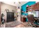 Inviting home office with wood floors, built-in shelves and desk, plus exercise equipment at 988 W Crooked Stick Dr, Casa Grande, AZ 85122