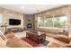 Comfortable living room showcases a stone fireplace, neutral walls, and cozy leather seating at 988 W Crooked Stick Dr, Casa Grande, AZ 85122