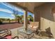 Inviting covered patio with outdoor seating and a view of the landscaped backyard at 988 W Crooked Stick Dr, Casa Grande, AZ 85122