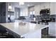 Modern kitchen boasts white cabinets, stainless steel appliances, and stylish backsplash at 1017 W Piccadilly Rd, Phoenix, AZ 85013