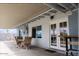 A covered outdoor patio features a dining set, double french doors, and a ceiling fan at 1017 W Piccadilly Rd, Phoenix, AZ 85013