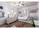Bright bedroom with hardwood floors, a daybed, a dresser, and large windows providing natural light at 1020 E Vermont Ave, Phoenix, AZ 85014