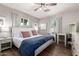 Inviting bedroom with a ceiling fan, a cozy bed, and natural light from the windows at 1020 E Vermont Ave, Phoenix, AZ 85014