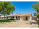 Well-maintained single-story home with extended carport and lush landscaping at 1020 E Vermont Ave, Phoenix, AZ 85014