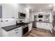 Bright kitchen features white cabinets, stainless steel appliances, and modern countertops at 1020 E Vermont Ave, Phoenix, AZ 85014