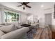 Cozy living room with hardwood floors, large window, and comfortable seating arrangement at 1020 E Vermont Ave, Phoenix, AZ 85014