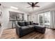 Comfortable living room featuring a skylight, ceiling fan, and sliding doors to the outdoors at 1020 E Vermont Ave, Phoenix, AZ 85014