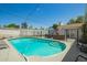 Sparkling pool with lounge chairs, a patio dining set, and secure fencing, perfect for outdoor relaxation and entertainment at 1020 E Vermont Ave, Phoenix, AZ 85014