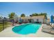 Backyard pool with chairs and patio furniture surrounded by a fence, offering a perfect spot for relaxation and recreation at 1020 E Vermont Ave, Phoenix, AZ 85014