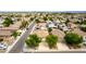 Wide aerial shot of a well-maintained residential area, showing landscaping, solar panels, and a clear view of the street layout at 1036 E Magnum Rd, San Tan Valley, AZ 85140