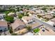 An aerial view of a Gathering friendly neighborhood with lush green landscaping, mature trees, and well maintained homes at 1036 E Magnum Rd, San Tan Valley, AZ 85140