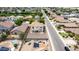 Aerial shot of a Gathering friendly neighborhood, with well-maintained homes and clean streets. Solar panels adorn many of the roofs at 1036 E Magnum Rd, San Tan Valley, AZ 85140