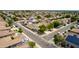 An aerial perspective highlights a neighborhood with varied home styles, mature trees, and solar panels for energy efficiency at 1036 E Magnum Rd, San Tan Valley, AZ 85140