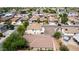 This aerial view of this home shows mature landscaping, a block-wall-enclosed yard, and roof in great condition at 1036 E Magnum Rd, San Tan Valley, AZ 85140