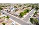A sunny aerial shot showcases a well-maintained neighborhood, featuring similar home styles and solar panels on various houses at 1036 E Magnum Rd, San Tan Valley, AZ 85140