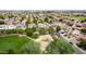 An aerial view of a neighborhood featuring homes, a playground, and mature trees, creating a Gathering-friendly community atmosphere at 1036 E Magnum Rd, San Tan Valley, AZ 85140