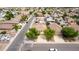 Aerial view of a neighborhood streetscape showing well-maintained homes with mature landscaping and tile roofs at 1036 E Magnum Rd, San Tan Valley, AZ 85140