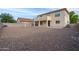 This backyard has a fountain feature, block wall, gravel landscaping, and a covered patio to relax on at 1036 E Magnum Rd, San Tan Valley, AZ 85140