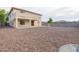 This backyard offers gravel landscaping, a fountain feature, a covered patio, and block wall fencing at 1036 E Magnum Rd, San Tan Valley, AZ 85140