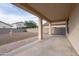 This covered patio backyard has a brick-lined concrete patio, fountain, gravel landscaping, and block wall at 1036 E Magnum Rd, San Tan Valley, AZ 85140