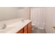 Bright bathroom features a dual sink vanity, toilet, and shower with a white curtain at 1036 E Magnum Rd, San Tan Valley, AZ 85140