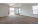 Expansive bedroom with neutral carpet, sliding glass doors, and bright windows at 1036 E Magnum Rd, San Tan Valley, AZ 85140