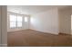 Neutral bedroom features carpeted floors and a large window, providing lots of natural light at 1036 E Magnum Rd, San Tan Valley, AZ 85140